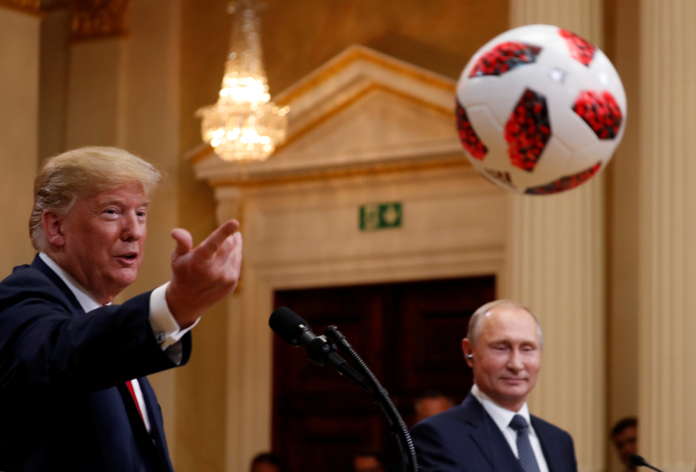 U.S. President Donald Trump throws a football to U.S. First Lady Melania Trump during a joint news conference with Russia's President Vladimir Putin after their meeting in Helsinki, Finland, July 16, 2018. REUTERS/Kevin Lamarque