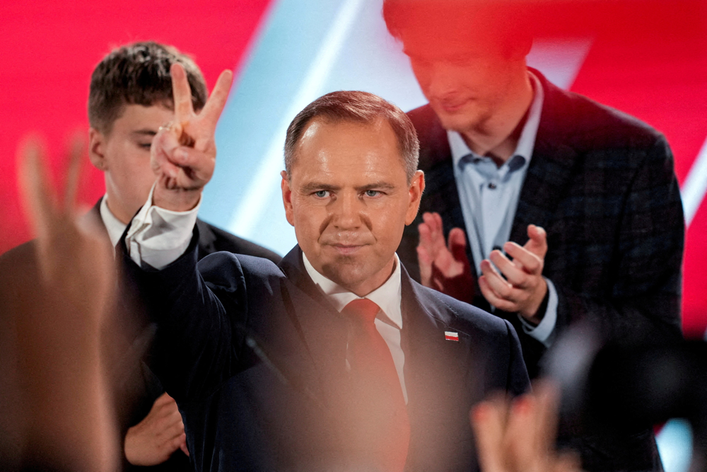 FILE PHOTO: Polish presidential candidate Karol Nawrocki, backed by the main opposition Law and Justice (PiS) party, reacts to the exit polls of the second round of the presidential election, in Warsaw, Poland, June 1, 2025. REUTERS/Aleksandra Szmigiel/File Photo