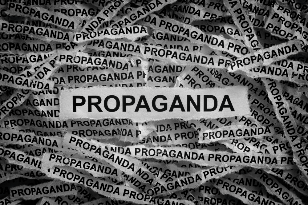 Strips of newspaper with the words Propaganda typed on them. Black and white. Close up.  IDEOLOŠKO BRENDIRANJE